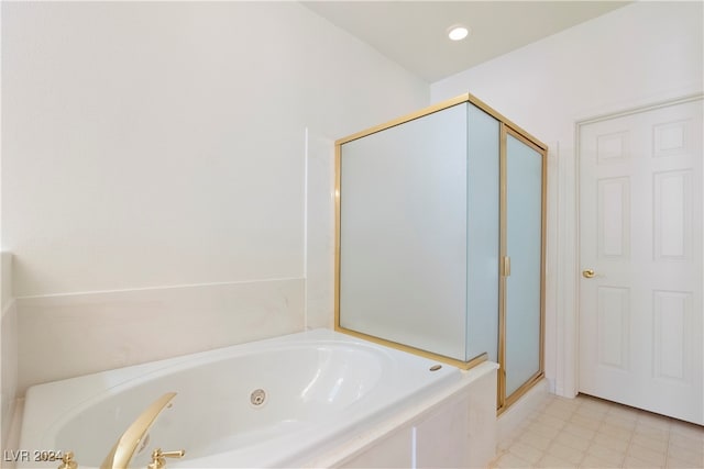 bathroom featuring tile patterned flooring and independent shower and bath