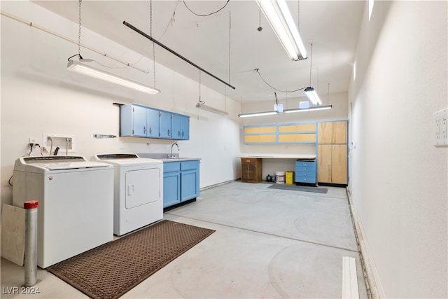 laundry room with sink, washer and clothes dryer, cabinets, and a towering ceiling