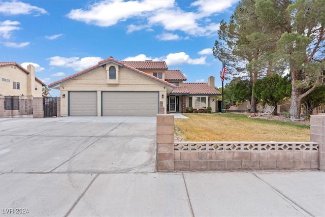 mediterranean / spanish-style house with a front yard, fence, a garage, and driveway