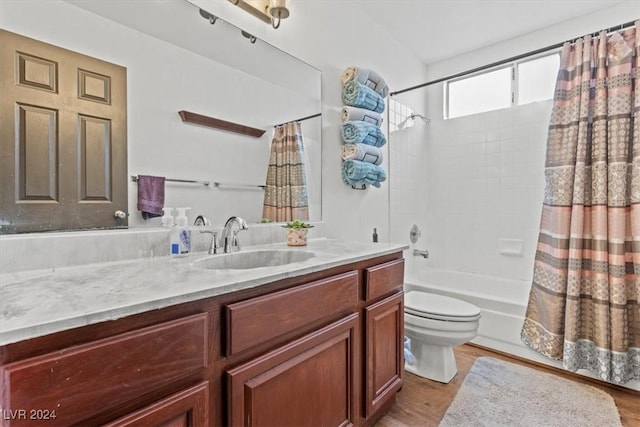 full bath featuring vanity, toilet, wood finished floors, and shower / bath combo