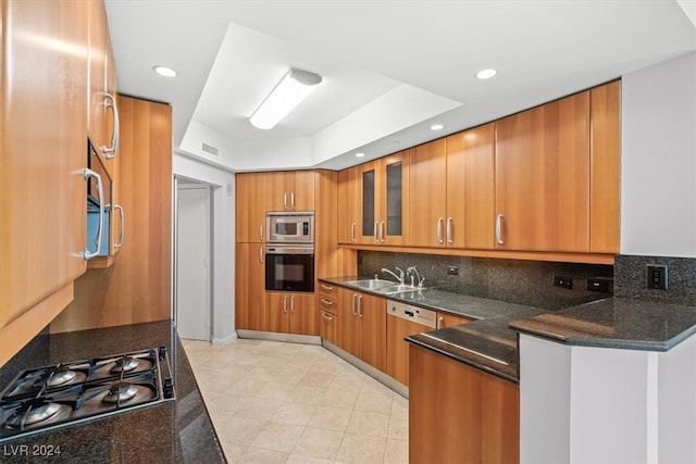 kitchen featuring dark stone countertops, backsplash, appliances with stainless steel finishes, sink, and light tile patterned flooring