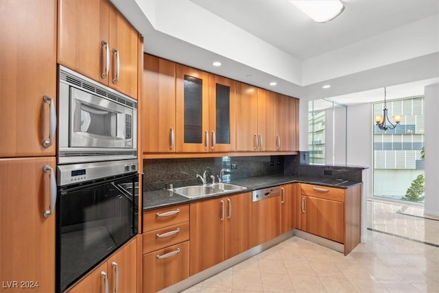 kitchen with a notable chandelier, light tile patterned floors, decorative backsplash, black oven, and stainless steel microwave