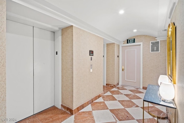 hall featuring light tile patterned floors and elevator