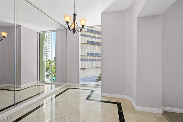 entryway featuring a chandelier, floor to ceiling windows, and light tile patterned flooring