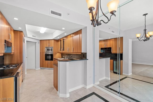 kitchen featuring stainless steel appliances, decorative backsplash, hanging light fixtures, a tray ceiling, and light colored carpet