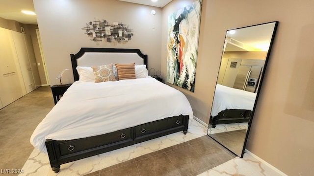 bedroom with a closet and tile patterned floors