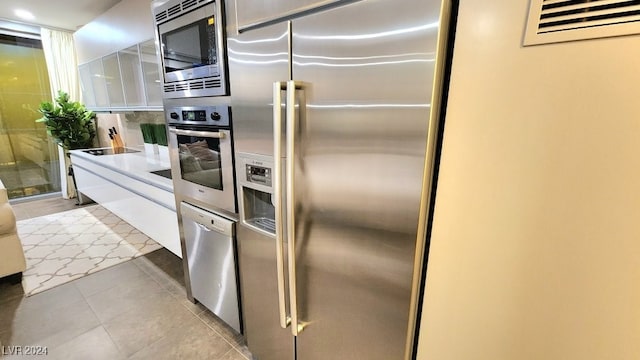 kitchen with appliances with stainless steel finishes and tile patterned floors