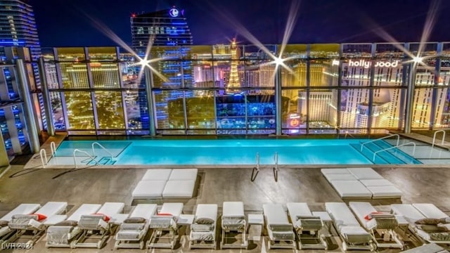 view of pool at twilight