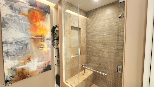 bathroom featuring a shower with shower door