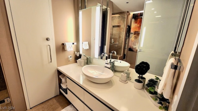 bathroom with a shower with shower door, tile patterned flooring, and vanity