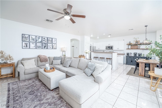 tiled living room with ceiling fan