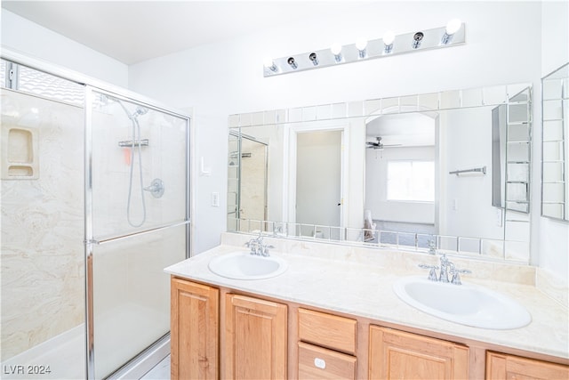 bathroom featuring vanity, walk in shower, and ceiling fan