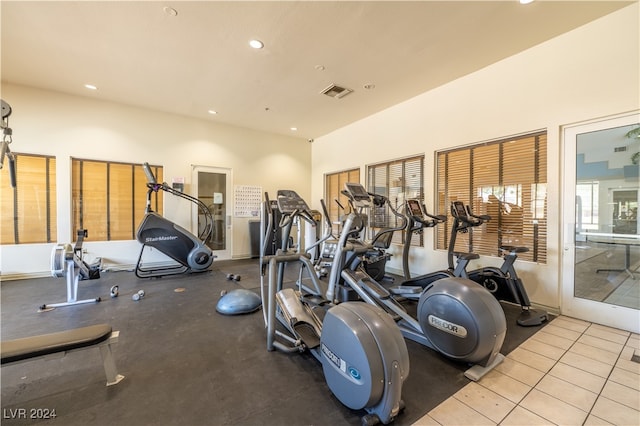 workout area featuring light tile patterned floors