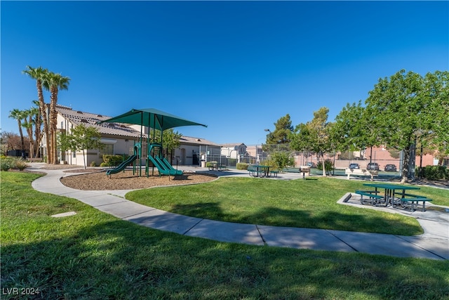 view of property's community featuring a playground and a lawn