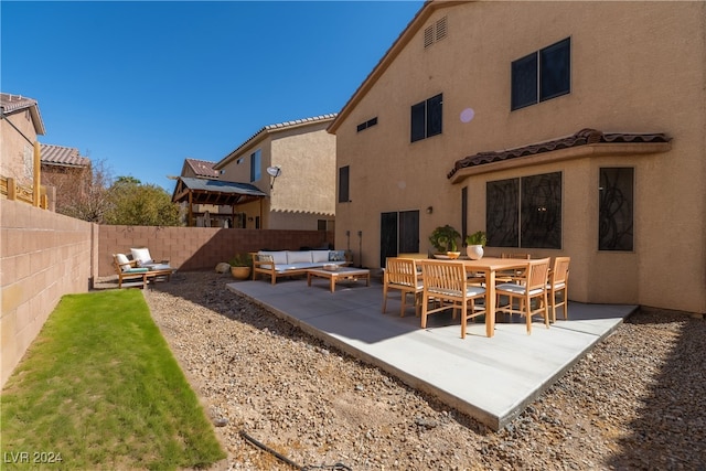 rear view of property with an outdoor hangout area and a patio area