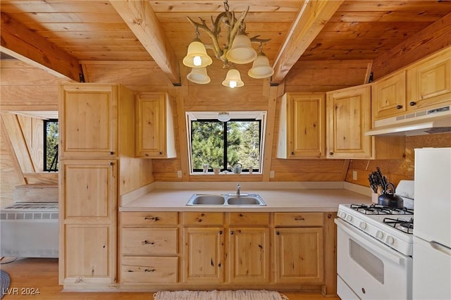 kitchen with white appliances, a sink, under cabinet range hood, and light brown cabinetry