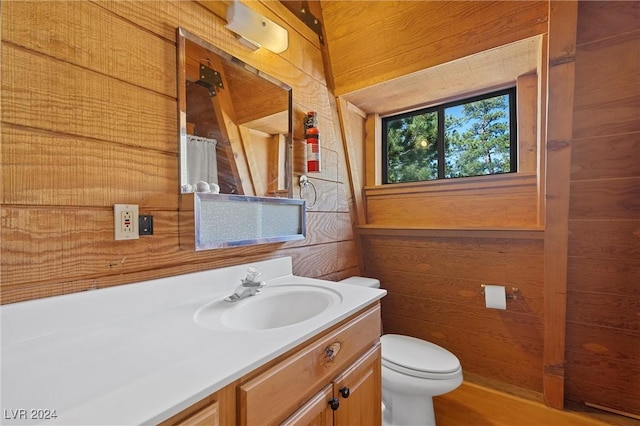 full bathroom featuring wooden walls, toilet, a shower with shower curtain, and vanity