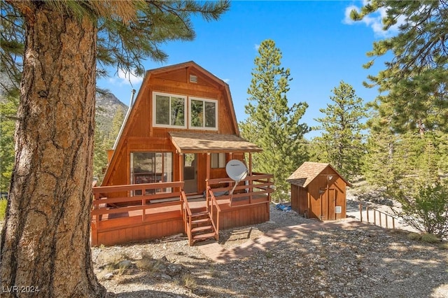 view of front facade with a shed and a deck