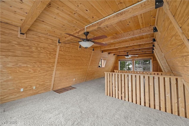 bonus room with carpet floors, beam ceiling, wooden walls, wooden ceiling, and a ceiling fan