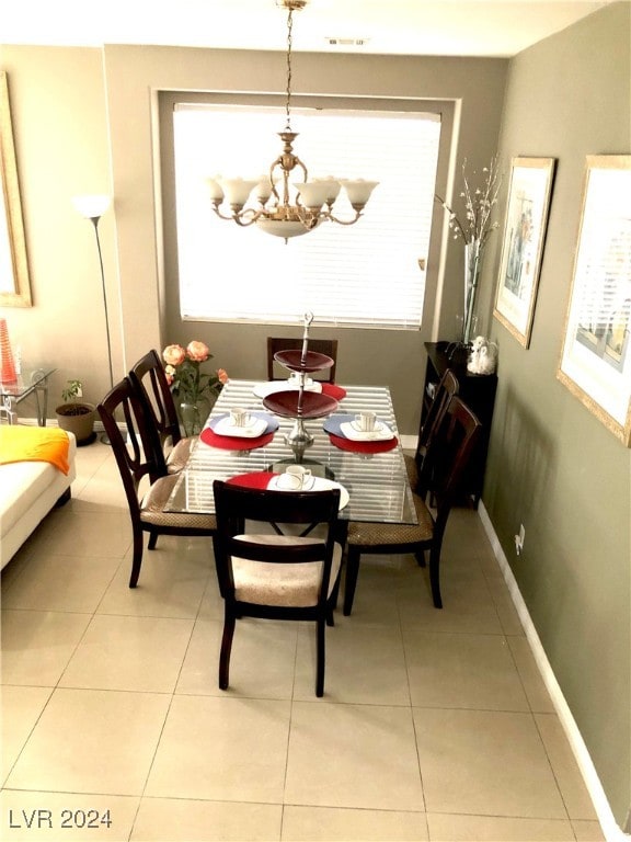 dining space with an inviting chandelier and light tile patterned floors