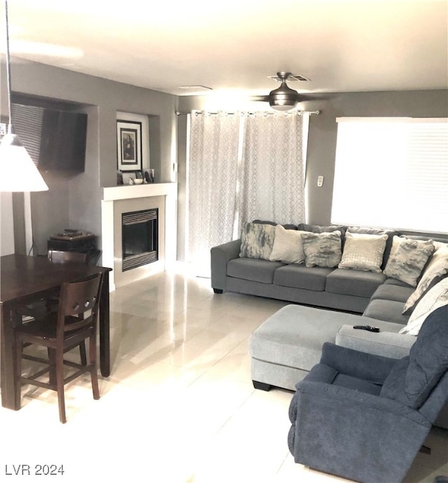 tiled living room with ceiling fan