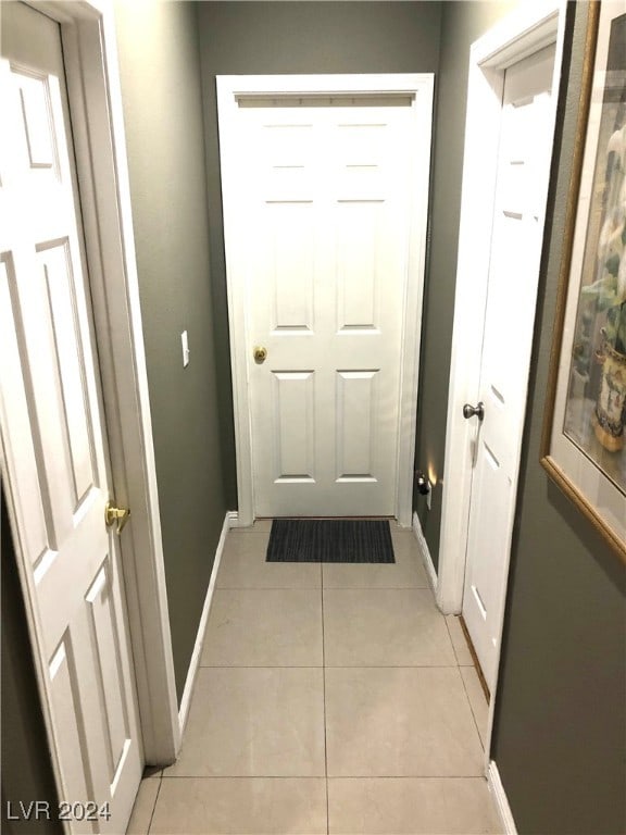 doorway with light tile patterned floors