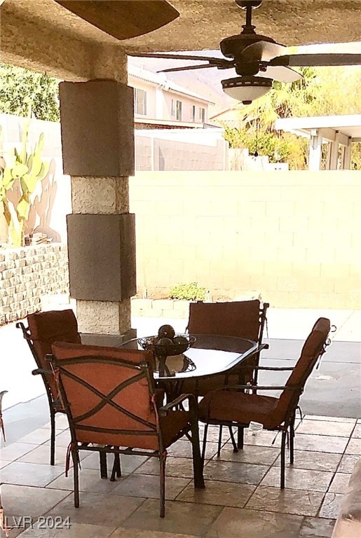 dining space with ceiling fan and tile patterned floors