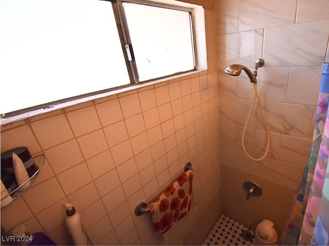 bathroom featuring walk in shower and tile walls