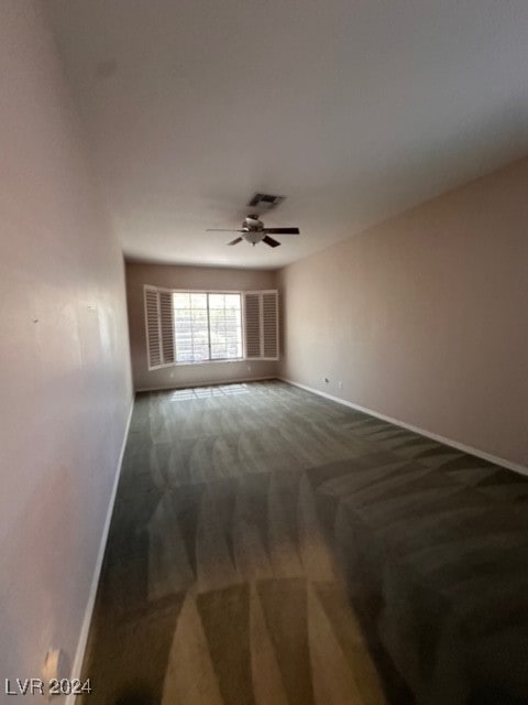 spare room with ceiling fan and carpet flooring