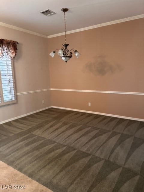 carpeted spare room featuring a chandelier and ornamental molding