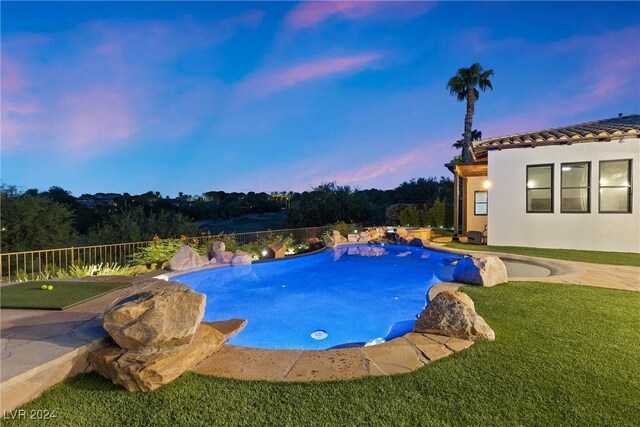 pool at dusk with a yard