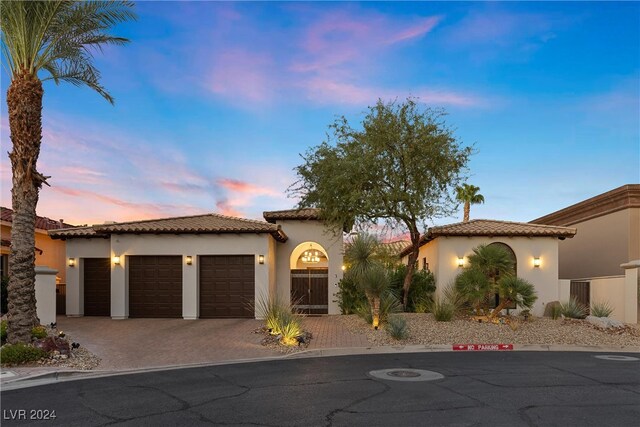 mediterranean / spanish house featuring a garage