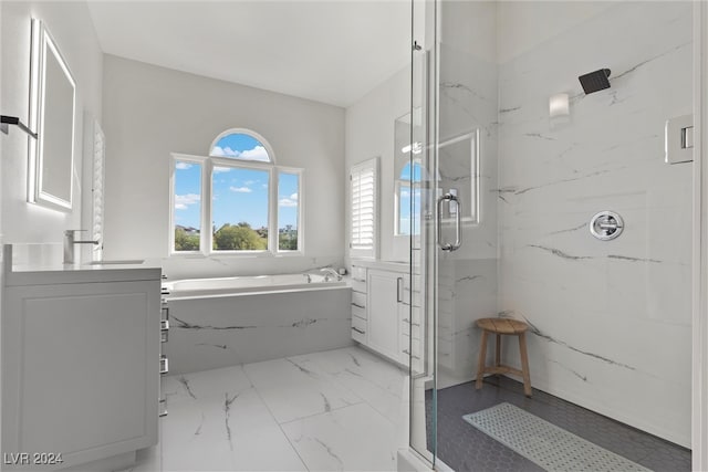 bathroom featuring shower with separate bathtub, tile patterned floors, and vanity