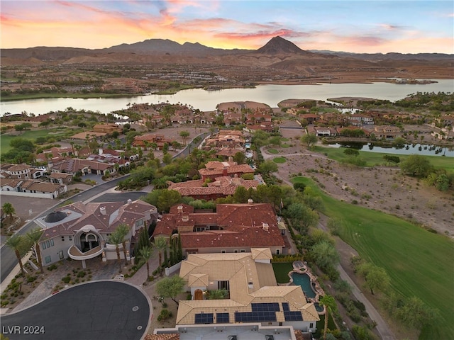 aerial view at dusk with a water and mountain view