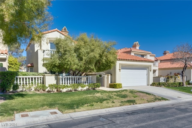 mediterranean / spanish-style house featuring a front yard and a garage