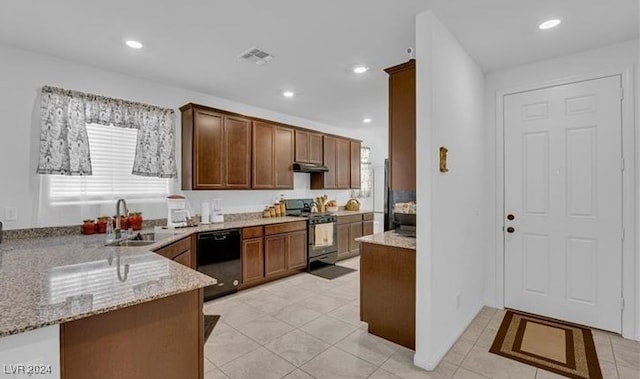 kitchen with stainless steel range oven, light stone counters, light tile patterned floors, sink, and black dishwasher