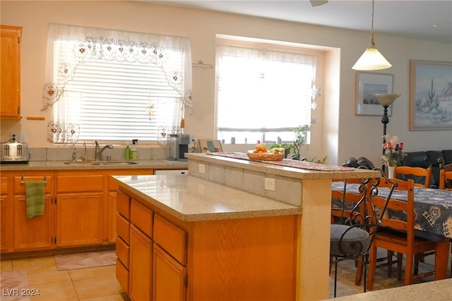 kitchen featuring sink, pendant lighting, and light tile patterned flooring