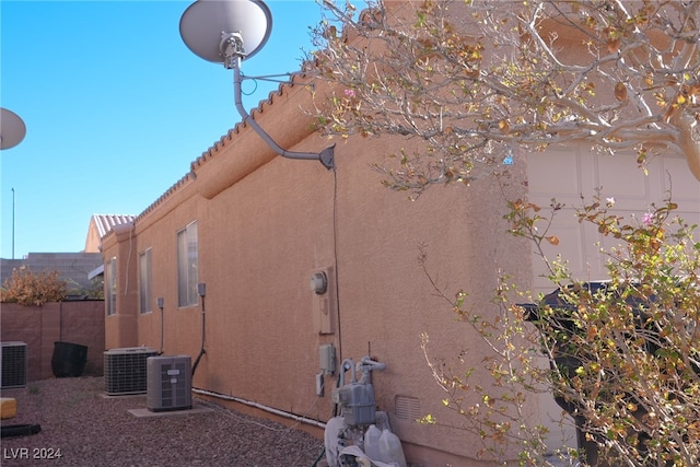 view of side of home with central air condition unit