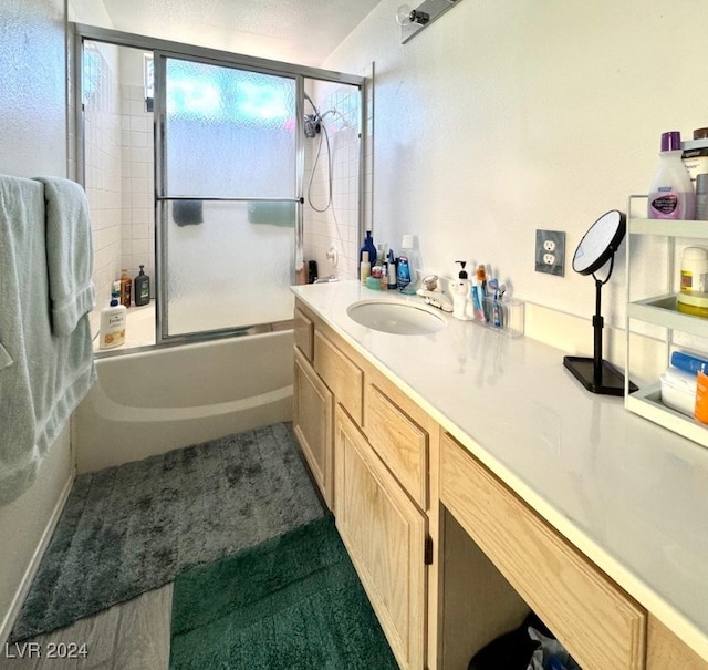 bathroom featuring vanity and enclosed tub / shower combo