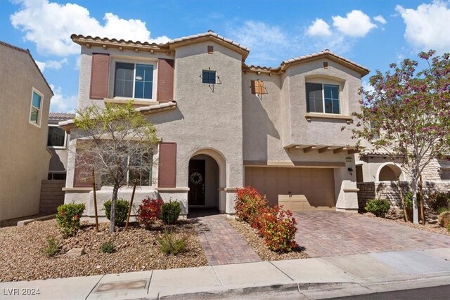 mediterranean / spanish house with a garage