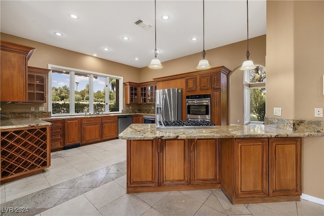 kitchen featuring stainless steel appliances, decorative light fixtures, kitchen peninsula, and light stone countertops