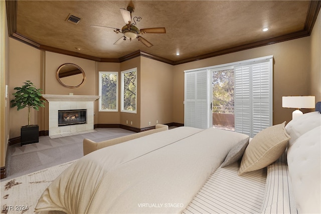 carpeted bedroom featuring multiple windows, access to exterior, crown molding, and a fireplace