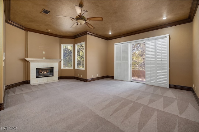 unfurnished living room featuring crown molding, a fireplace, light colored carpet, and a wealth of natural light