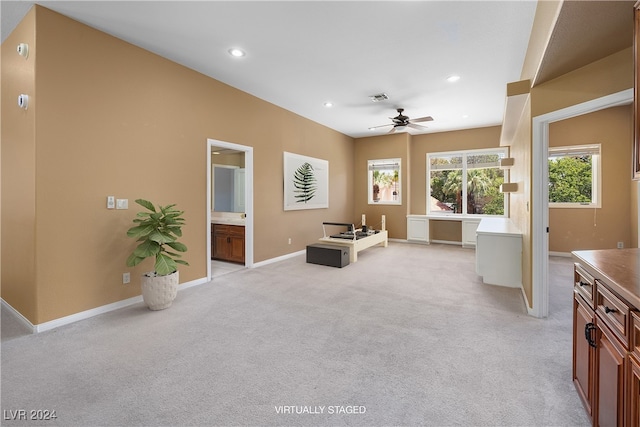 sitting room with light colored carpet and ceiling fan