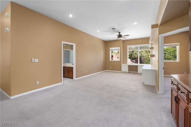 interior space with ceiling fan and light carpet