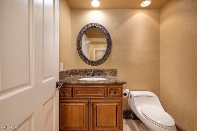 bathroom with vanity and toilet