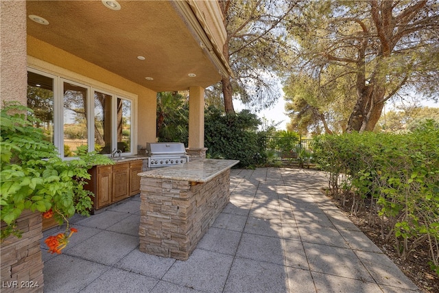 view of patio / terrace with grilling area, exterior kitchen, and sink