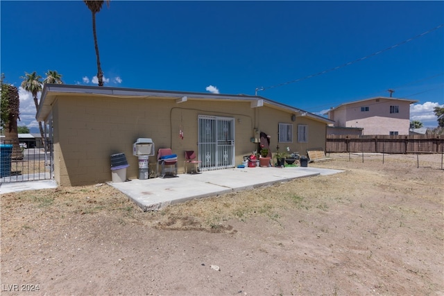 rear view of property featuring a patio area