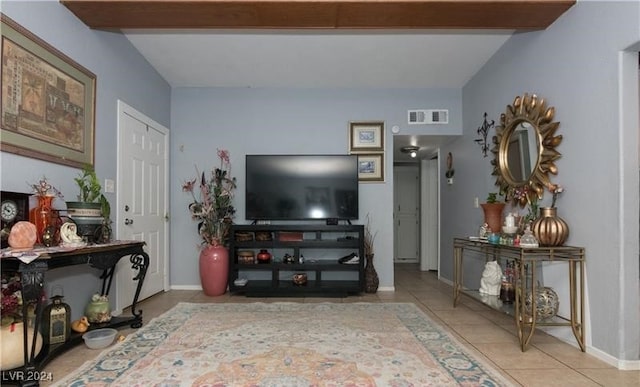 tiled living room featuring beam ceiling