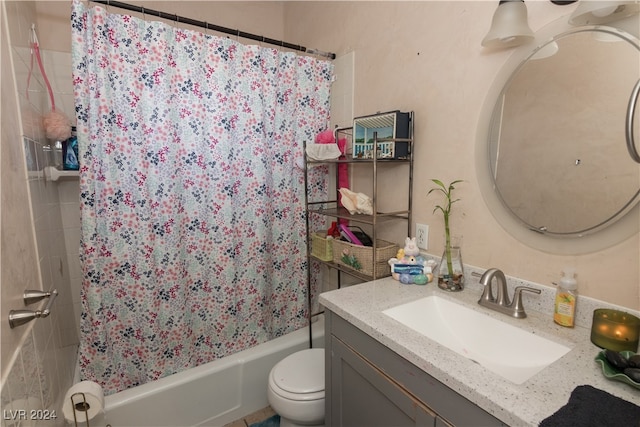 full bathroom with vanity, shower / tub combo, and toilet